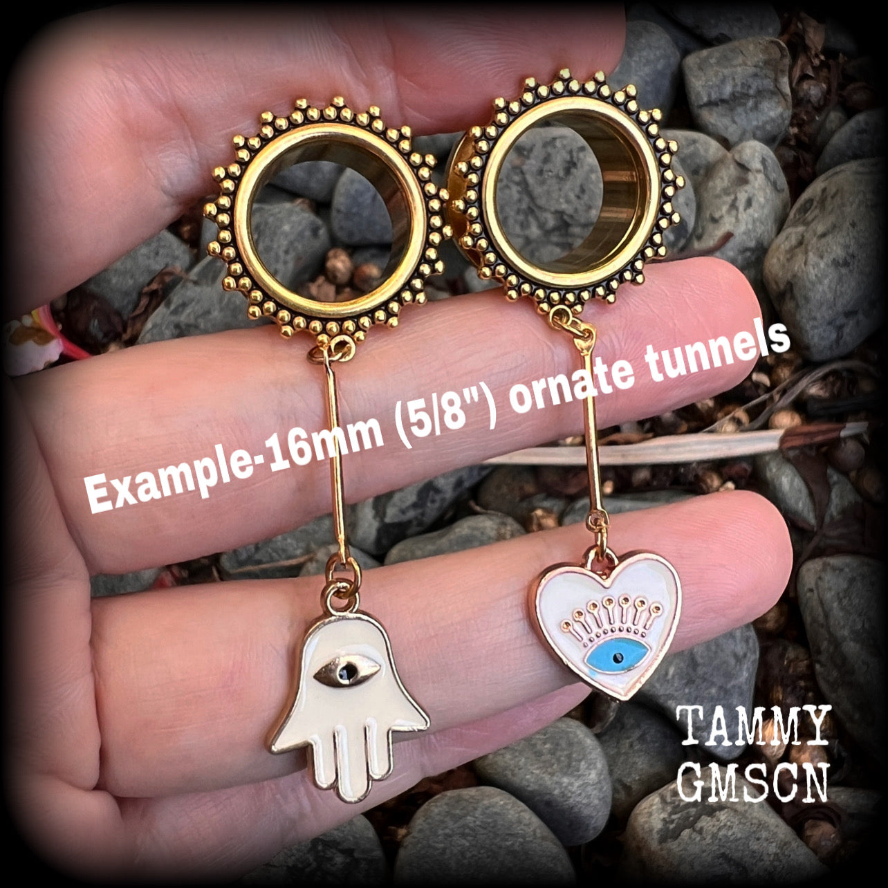 These tunnel earrings feature gold enamel hamsa hand and evil eye charms, weighing approx 9 grams each and measuring just over 6cms.
This pair have been made with 5/8" (16mm) gauge ornate titanium coated surgical steel screw fit tunnels.
