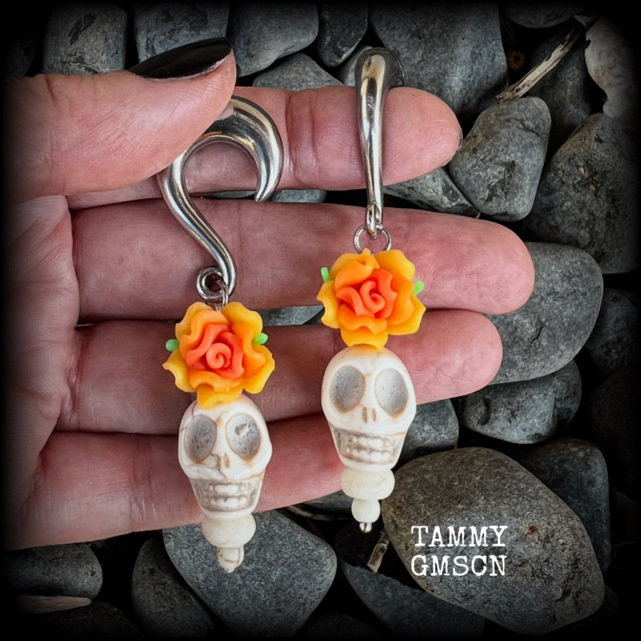 Featuring gorgeous orange and canary yellow roses sitting atop bone white stone skulls, these earrings have been made especially for Day of the Dead celebrations!

These unique earrings are nice and light weight at 15 grams a piece, and nice and dangly at just on 7.5cms from tip to tip.

This pair of beautiful gauged earrings has been made with 0 gauge (8mm) surgical steel half curl hooks, suitable for stretched lobes.