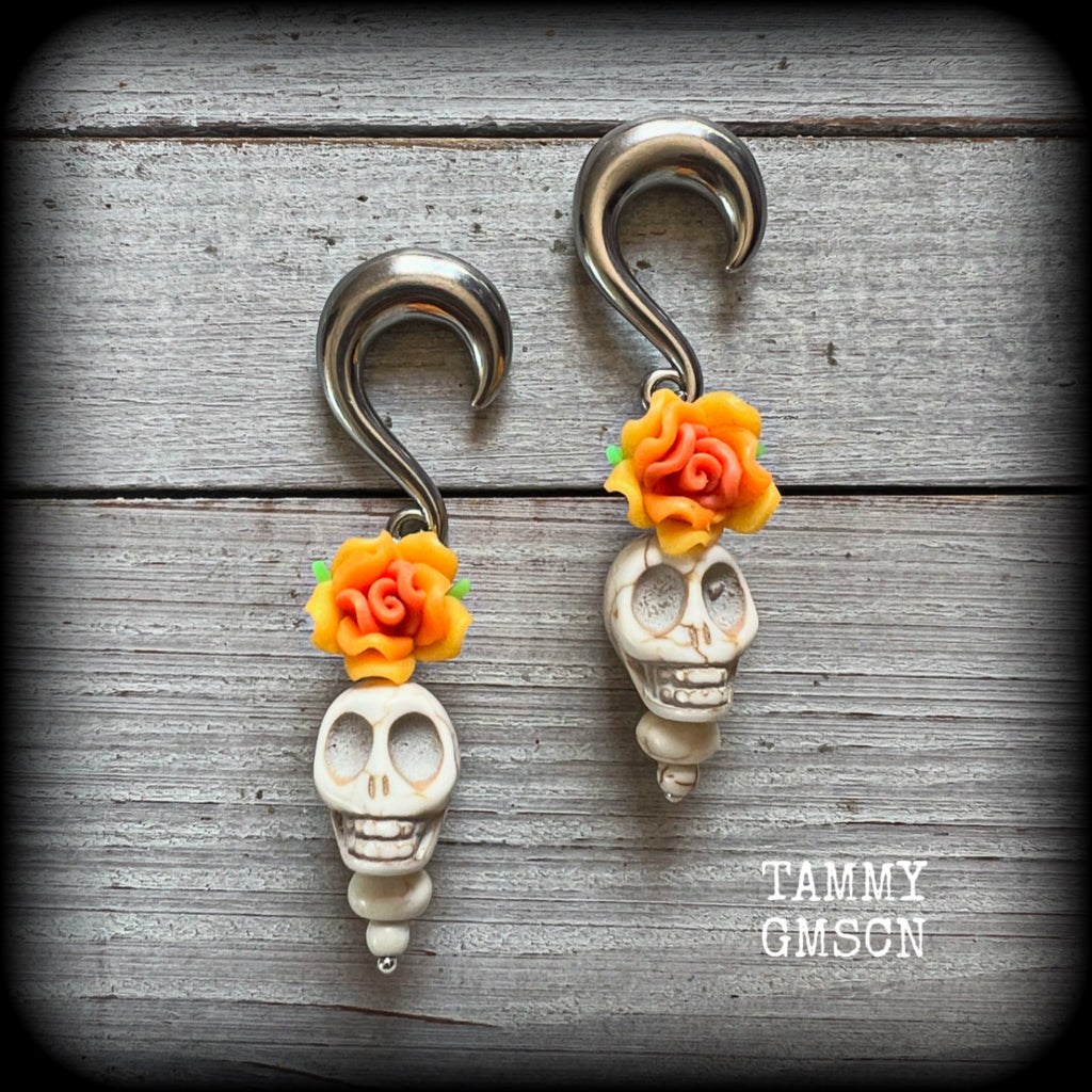Featuring gorgeous orange and canary yellow roses sitting atop bone white stone skulls, these earrings have been made especially for Day of the Dead celebrations!

These unique earrings are nice and light weight at 15 grams a piece, and nice and dangly at just on 7.5cms from tip to tip.

This pair of beautiful gauged earrings has been made with 0 gauge (8mm) surgical steel half curl hooks, suitable for stretched lobes.
