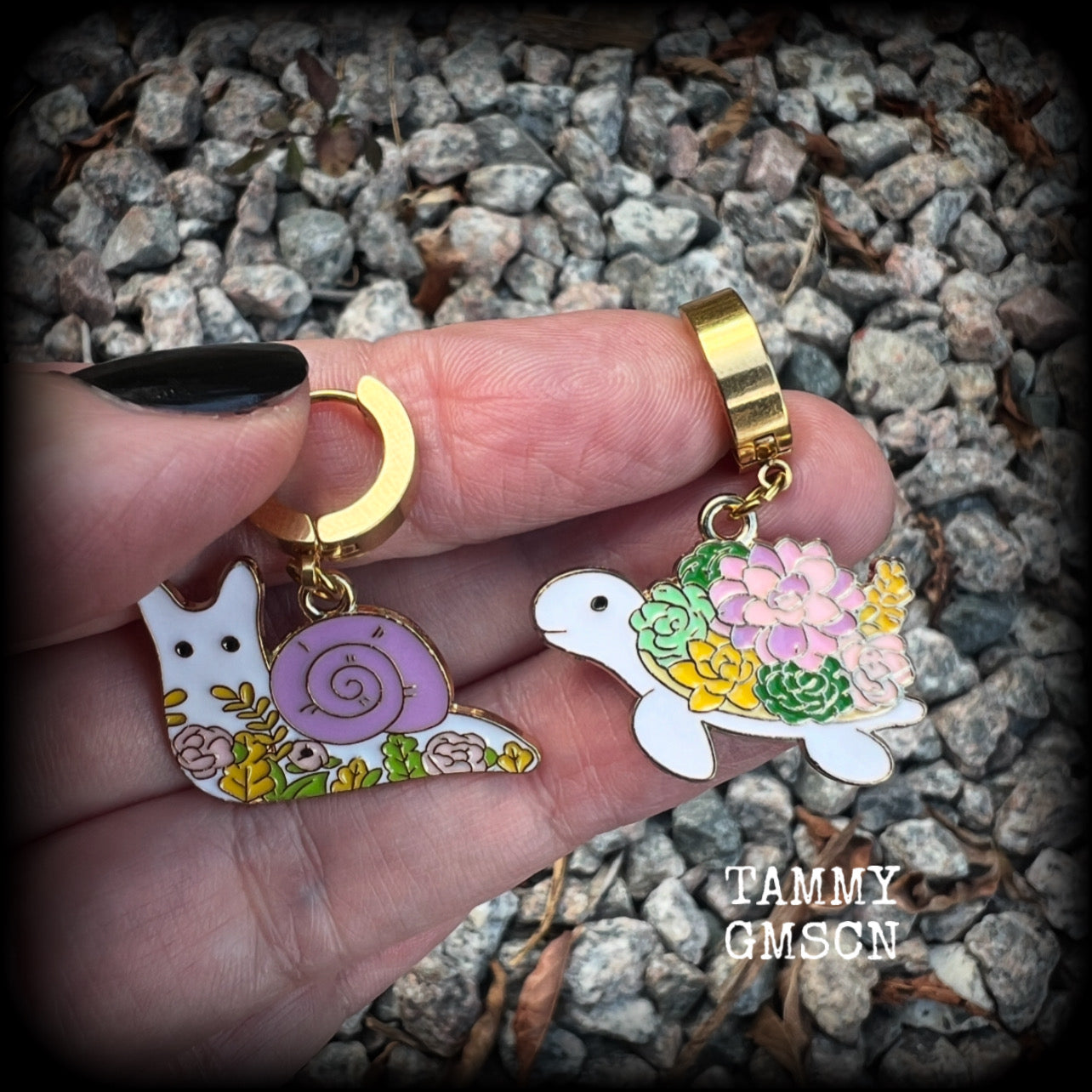 These adorable earrings feature antique gold and enamel garden snails and turtles with floral embellishments, are nice and lightweight at only a few grams each, and measure in at approx 4cm from tip to tip.

This pair have been made on stainless steel huggie ear cuffs, suitable for pierced ears.
