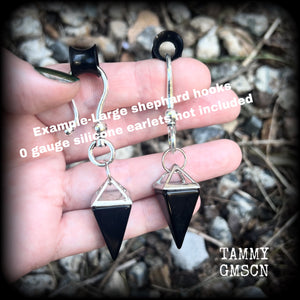 This is a pair of gorgeous pitch black onyx gemstone earrings, not too heavy at approx 10 grams a piece, and measuring just on 7cms from tip to tip.

This pair has been made with large antique silver shephards hooks, to be worn through silicone earlets in stretched lobes from 2 gauge (6mm).