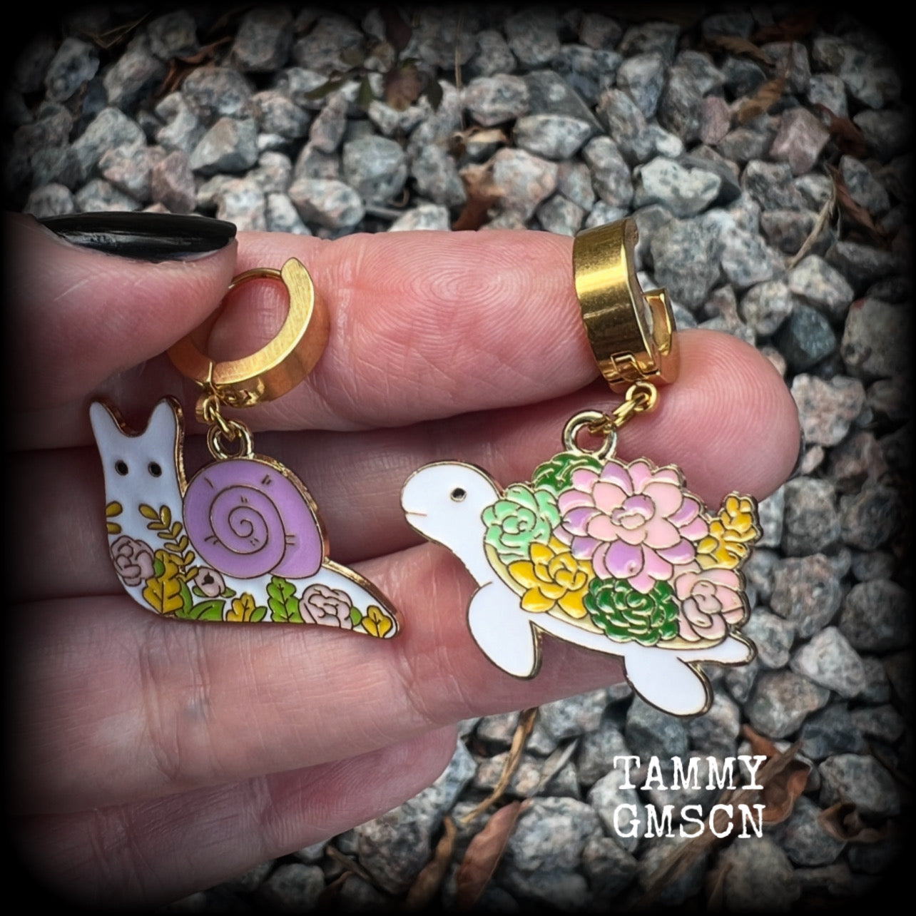 These adorable earrings feature antique gold and enamel garden snails and turtles with floral embellishments, are nice and lightweight at only a few grams each, and measure in at approx 4cm from tip to tip.

This pair have been made on stainless steel huggie ear cuffs, suitable for pierced ears.

