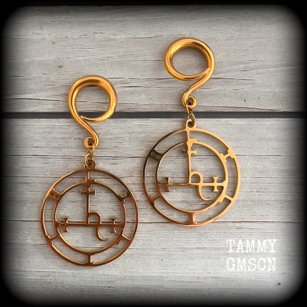These gorgeous gold stainless steel earrings feature the Sigil of Lilith as it appears in The Lesser Key of Solomon, and are lovely and light weight, weighing only 7 grams each, and measure just on 7cms from tip to tip.

This pair has been made with 6 gauge (4mm) surgical steel full curl hooks, to be worn in stretched lobes..