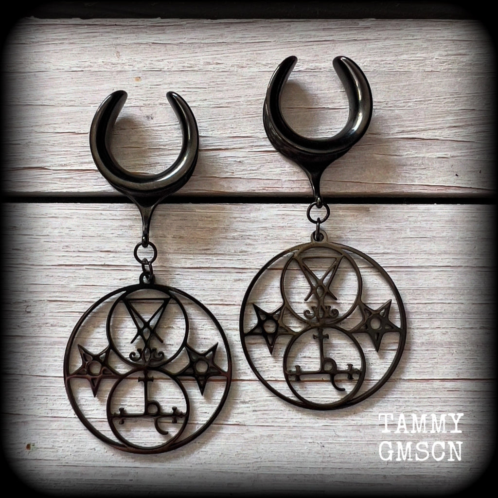 These gorgeous stainless steel earrings feature the Sigil of Lilith with the Sigil of Lucifer flanked by inverted pentagrams on each side. These earrings are lovely and light weight, weighing approx 9 grams each, and measure just on 7.5 cms from tip to tip.

This pair has been made on 3/4” gauge (19mm) surgical steel cradle hooks, to be worn in stretched lobes.