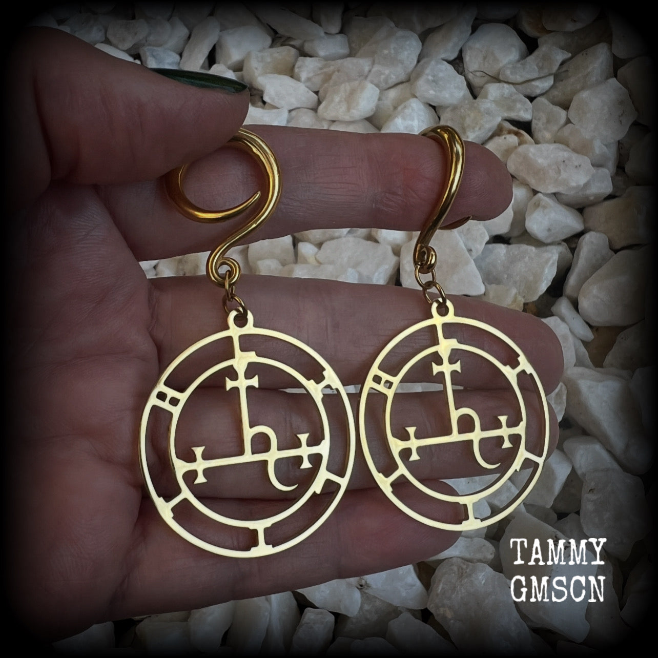 These gorgeous gold stainless steel earrings feature the Sigil of Lilith as it appears in The Lesser Key of Solomon, and are lovely and light weight, weighing only 7 grams each, and measure just on 7cms from tip to tip.

This pair has been made with 6 gauge (4mm) surgical steel full curl hooks, to be worn in stretched lobes..