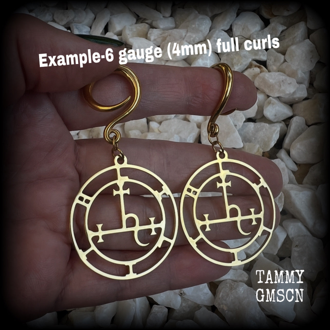 These gorgeous gold stainless steel earrings feature the Sigil of Lilith as it appears in The Lesser Key of Solomon, and are lovely and light weight, weighing only 7 grams each, and measure just on 7cms from tip to tip.

This pair has been made with 6 gauge (4mm) surgical steel full curl hooks, to be worn in stretched lobes..