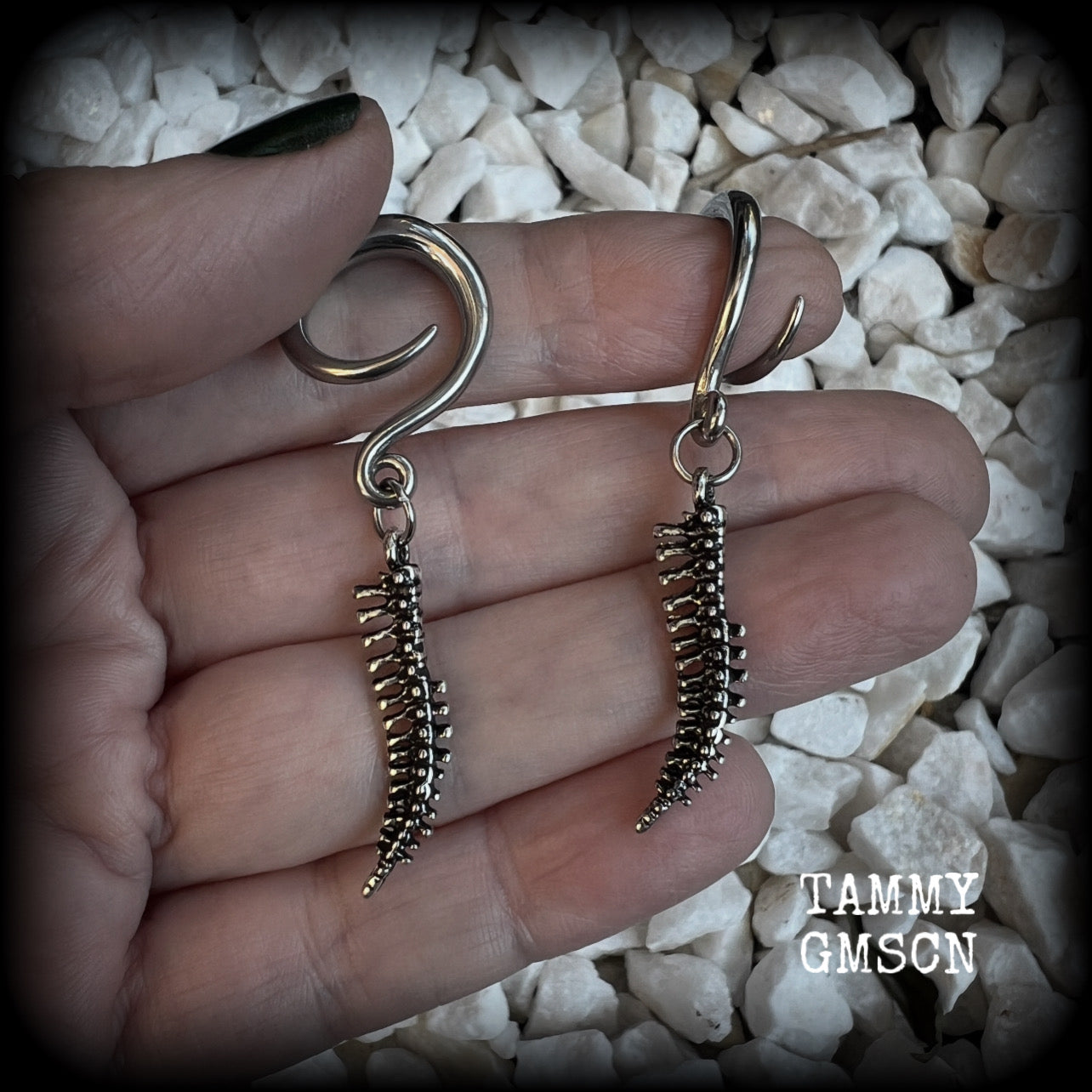 Featuring a pair of awesome antique silver spinal cords, these earrings are super lightweight, weighing in at only 3 grams a piece, and are nice and dangly at just on 5.5cms.

This pair has been made on 6 gauge (4mm) surgical steel full curl hooks, to be worn in stretched lobes.