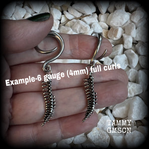 Featuring a pair of awesome antique silver spinal cords, these earrings are super lightweight, weighing in at only 3 grams a piece, and are nice and dangly at just on 5.5cms.

This pair has been made on 6 gauge (4mm) surgical steel full curl hooks, to be worn in stretched lobes.
