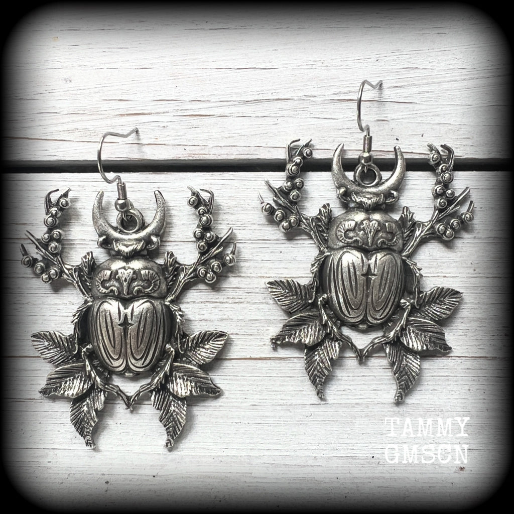 These gorgeous earrings feature big beautiful antique silver beetles surrounded by berries and leaves, weighing 14 grams each and measuring just on 6.5cms from tip to tip.

This pair have been made on stainless steel french hooks, suitable for pierced ears.
