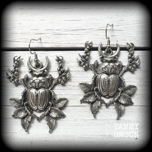 These gorgeous earrings feature big beautiful antique silver beetles surrounded by berries and leaves, weighing 14 grams each and measuring just on 6.5cms from tip to tip.

This pair have been made on stainless steel french hooks, suitable for pierced ears.