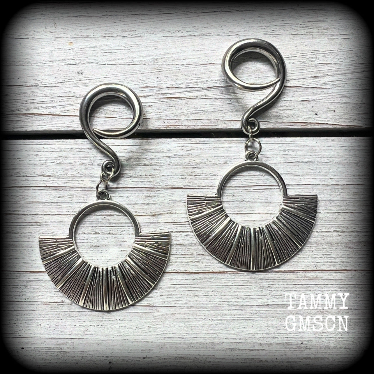 Inspired by Ishtar, Mesopotamian Goddess of love, beauty, sex and war, these unique ethnic inspired gauged earrings feature lovely dangly antique silver battle shields, nice and lightweight at approx 6 grams each, and nice and dangly at 6.5 cms from tip to tip.

This pair has been made on 6 gauge (4mm) surgical steel full curl hooks, to be worn in stretched lobes.