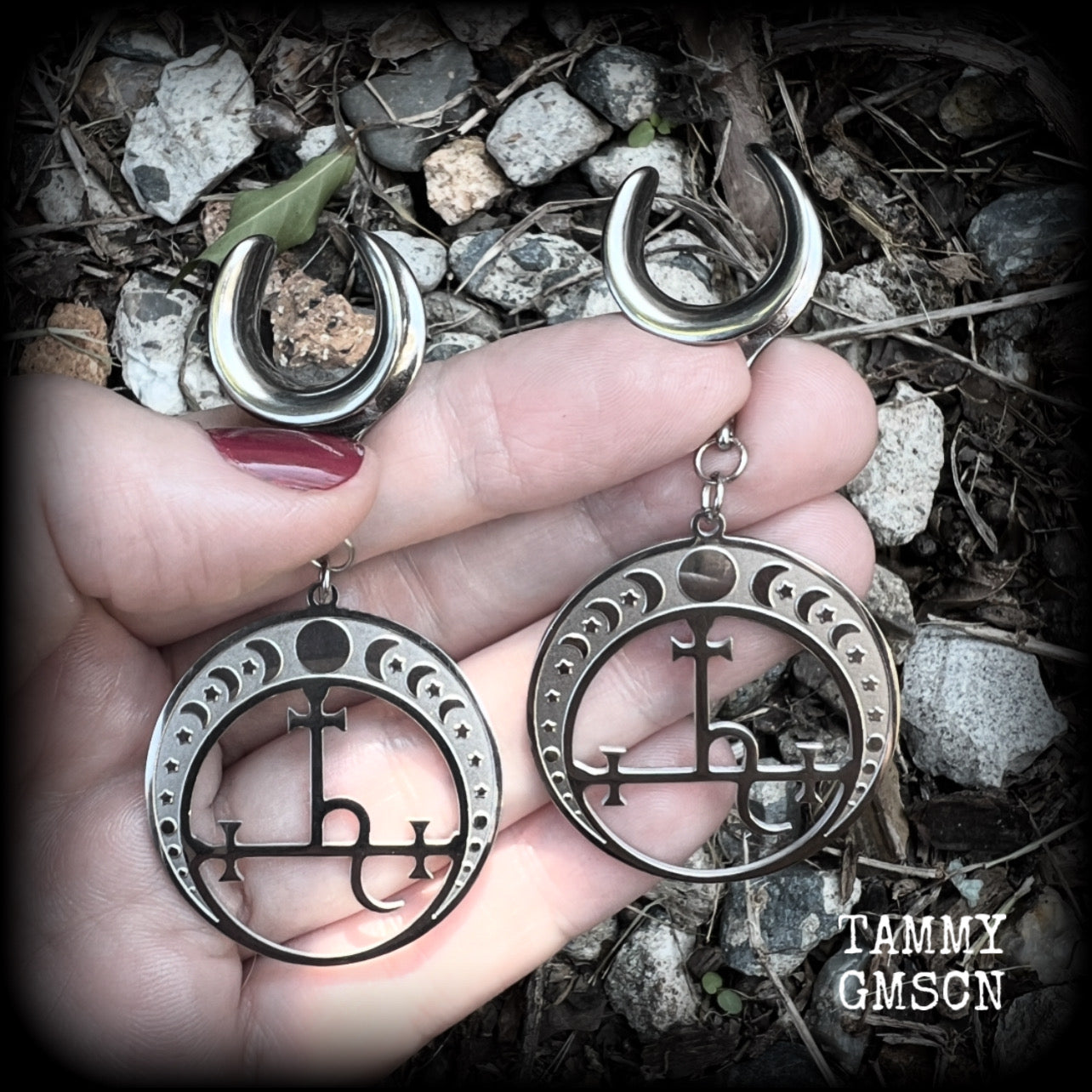These gorgeous stainless steel earrings feature the Sigil of Lilith surrounded by moon phases, lovely and light weight at only 9 grams each, and measure just over 7cms from tip to tip.  This pair has been made on 5/8” gauge (16mm) surgical steel cradles, for stretched lobes.