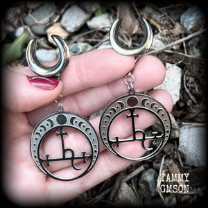 These gorgeous stainless steel earrings feature the Sigil of Lilith surrounded by moon phases, lovely and light weight at only 9 grams each, and measure just over 7cms from tip to tip.  This pair has been made on 5/8” gauge (16mm) surgical steel cradles, for stretched lobes.