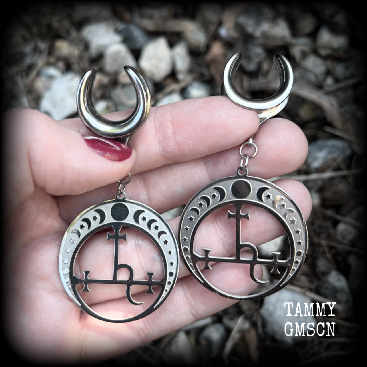 These gorgeous stainless steel earrings feature the Sigil of Lilith surrounded by moon phases, lovely and light weight at only 9 grams each, and measure just over 7cms from tip to tip.  This pair has been made on 5/8” gauge (16mm) surgical steel cradles, for stretched lobes.