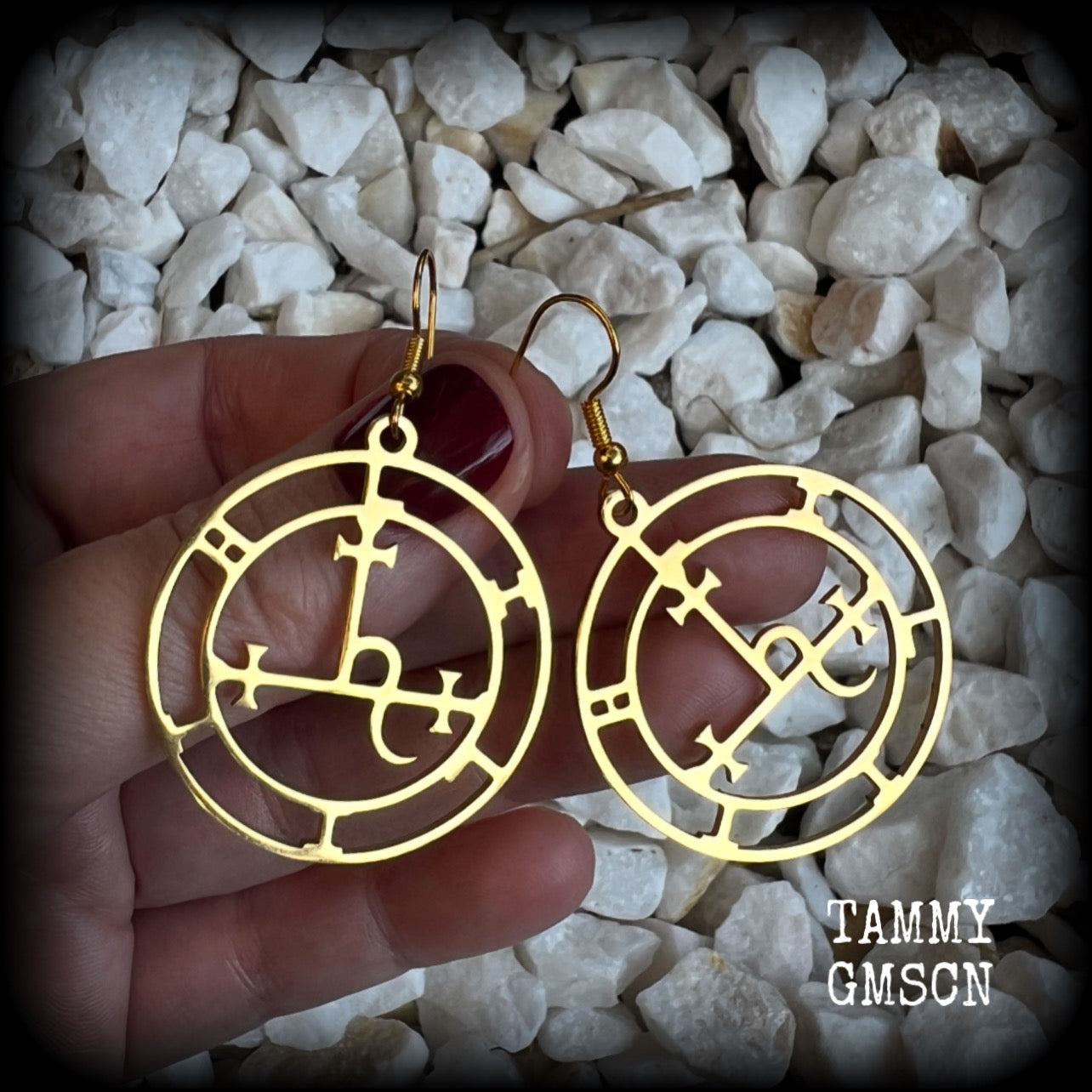 These gorgeous gold stainless steel earrings feature the Sigil of Lilith as it appears in The Lesser Key of Solomon, and are lovely and light weight, weighing only a few grams each, and measure just on 5.5cms from tip to tip.

This pair has been made with french hooks, suitable for pierced ears.