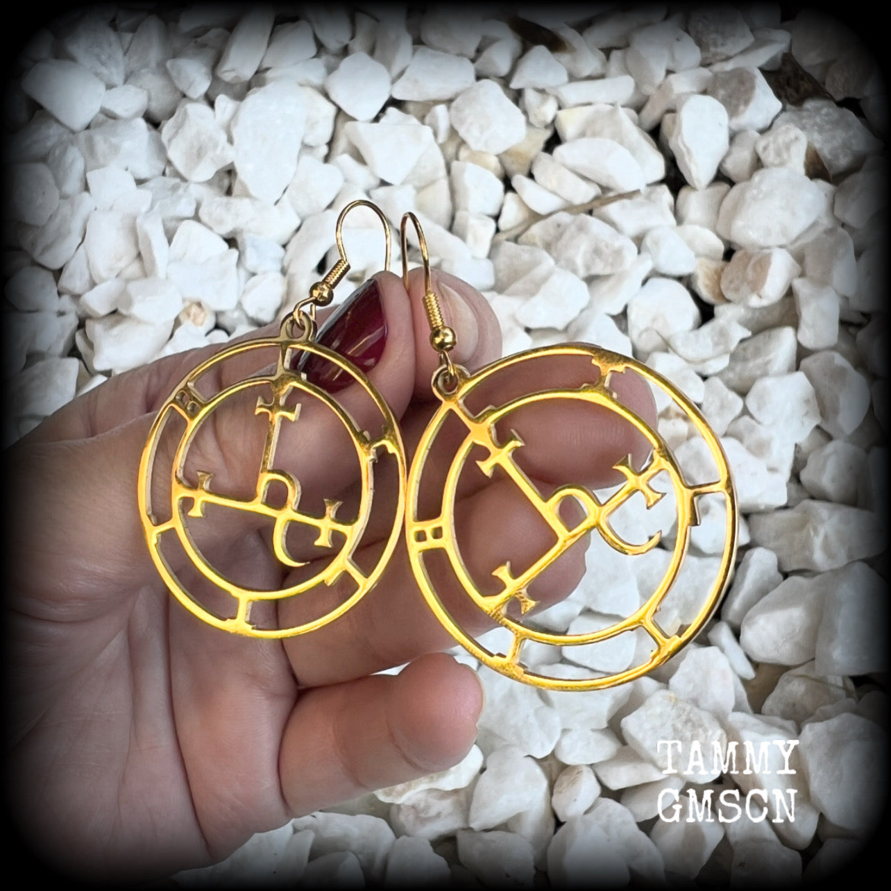 These gorgeous gold stainless steel earrings feature the Sigil of Lilith as it appears in The Lesser Key of Solomon, and are lovely and light weight, weighing only a few grams each, and measure just on 5.5cms from tip to tip.

This pair has been made with french hooks, suitable for pierced ears.