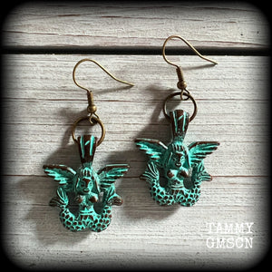 These unique earrings feature a pair of green patina double tail mermaids, measuring just over 5 cms from tip to tip, and weighing only 6 grams each.

This pair has been made on antique bronze french hooks, suitable for pierced ears or stretched lobes.