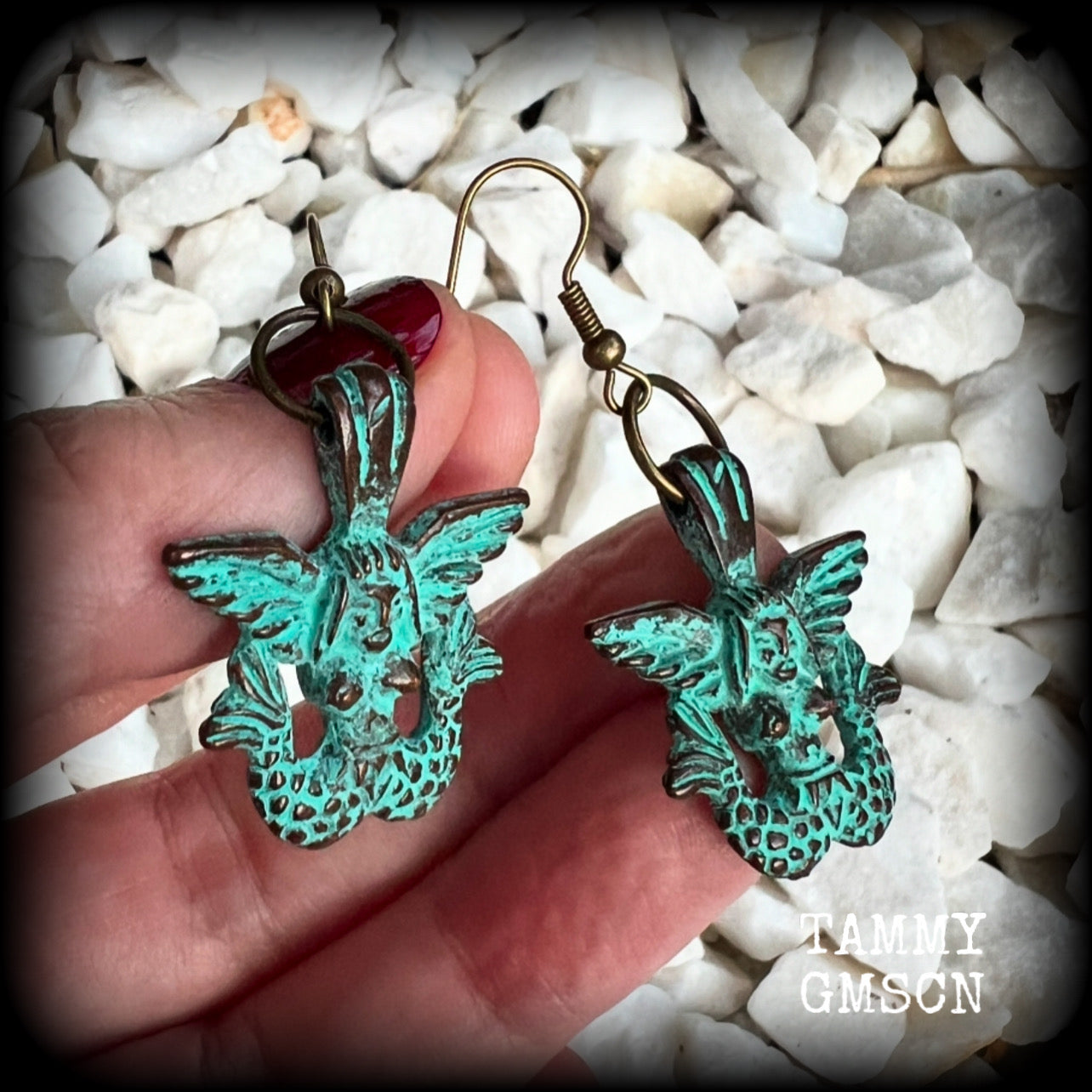 These unique earrings feature a pair of green patina double tail mermaids, measuring just over 5 cms from tip to tip, and weighing only 6 grams each.  This pair has been made on antique bronze french hooks, suitable for pierced ears or stretched lobes.