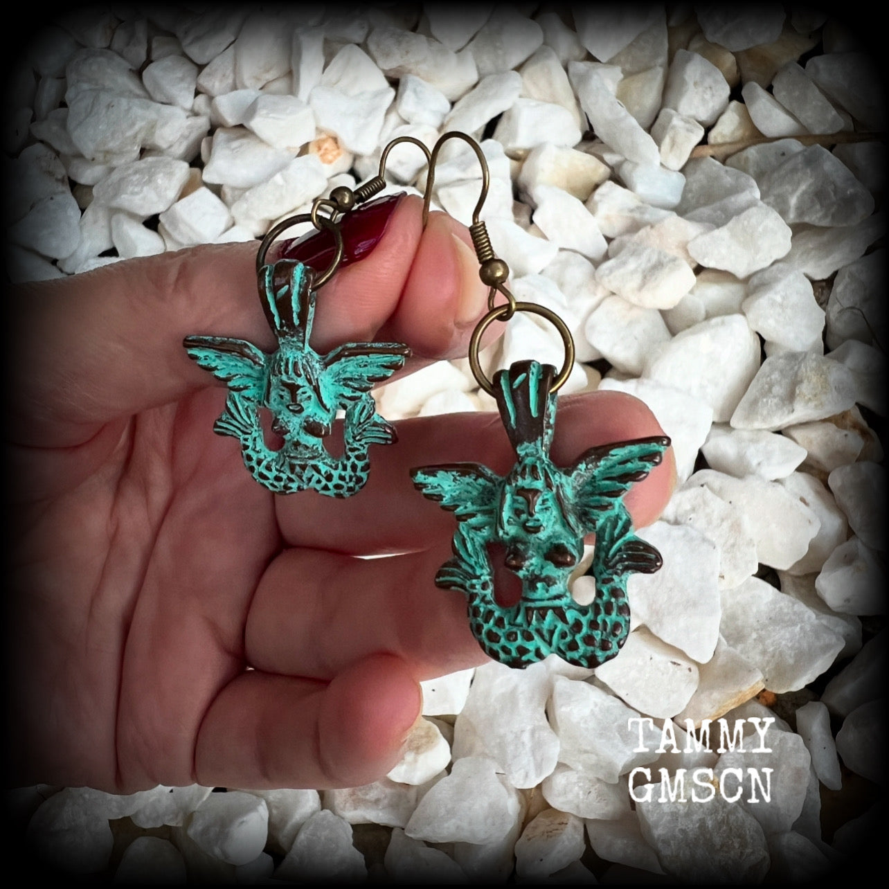 These unique earrings feature a pair of green patina double tail mermaids, measuring just over 5 cms from tip to tip, and weighing only 6 grams each.  This pair has been made on antique bronze french hooks, suitable for pierced ears or stretched lobes.