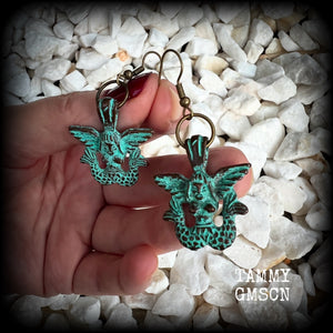 These unique earrings feature a pair of green patina double tail mermaids, measuring just over 5 cms from tip to tip, and weighing only 6 grams each.  This pair has been made on antique bronze french hooks, suitable for pierced ears or stretched lobes.