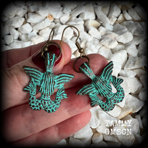 These unique earrings feature a pair of green patina double tail mermaids, measuring just over 5 cms from tip to tip, and weighing only 6 grams each.  This pair has been made on antique bronze french hooks, suitable for pierced ears or stretched lobes.