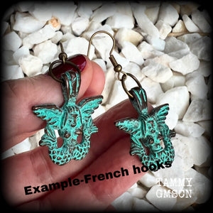 These unique earrings feature a pair of green patina double tail mermaids, measuring just over 5 cms from tip to tip, and weighing only 6 grams each.  This pair has been made on antique bronze french hooks, suitable for pierced ears or stretched lobes.