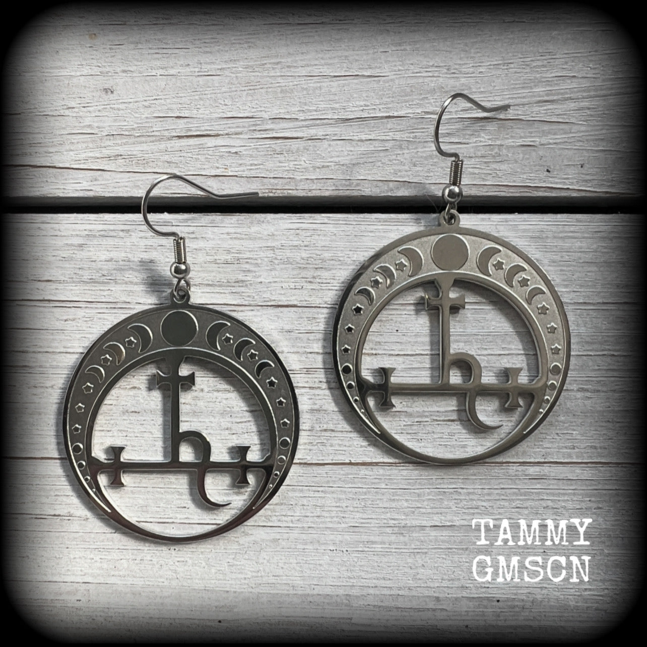 These gorgeous stainless steel earrings feature the Sigil of Lilith surrounded by moon phases, lovely and light weight at only 5 grams each, and measure just over 5.5cms from tip to tip.


This pair have been made with stainless steel french hooks, to be worn in pierced ears.
