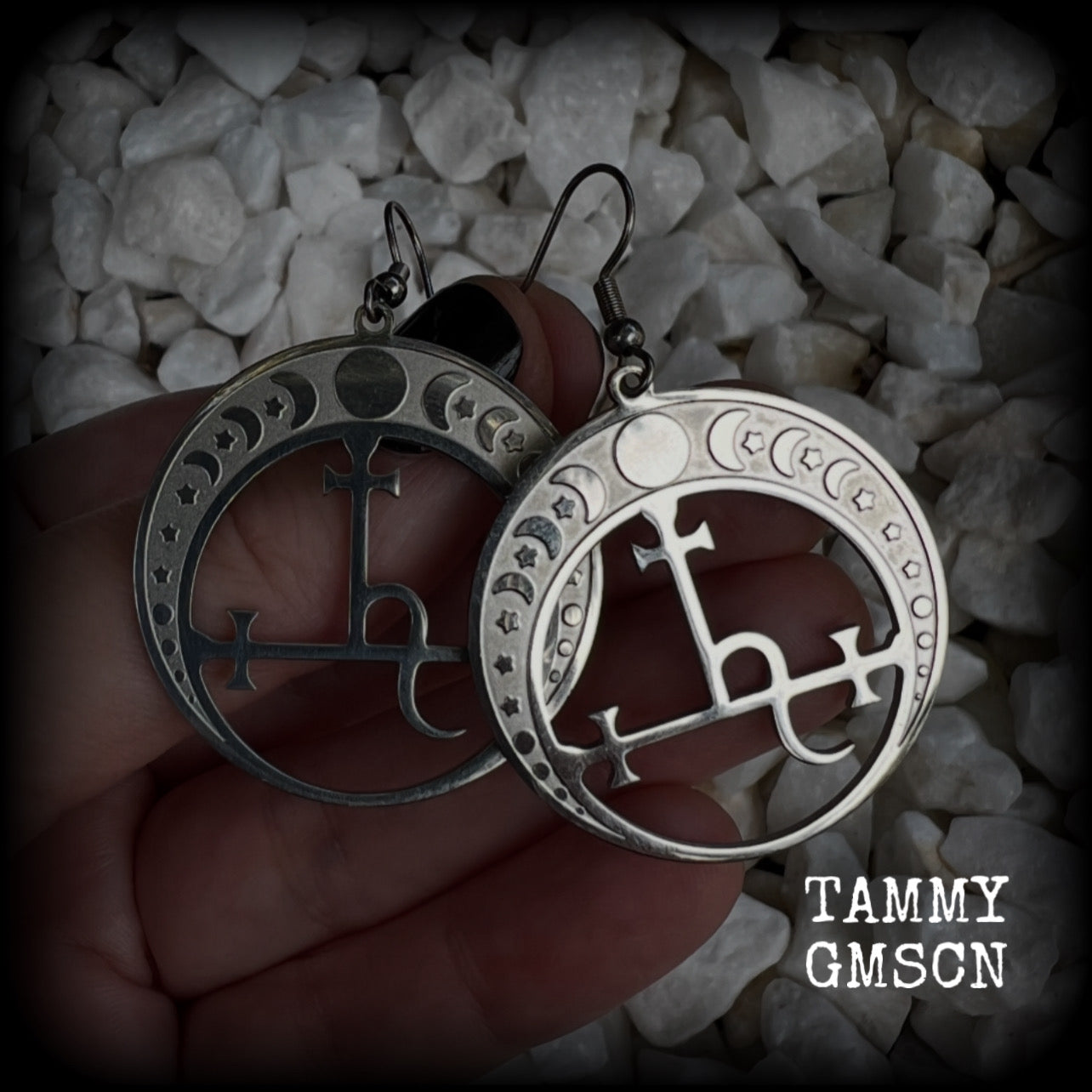 These gorgeous stainless steel earrings feature the Sigil of Lilith surrounded by moon phases, lovely and light weight at only 5 grams each, and measure just over 5.5cms from tip to tip.


This pair have been made with stainless steel french hooks, to be worn in pierced ears.
