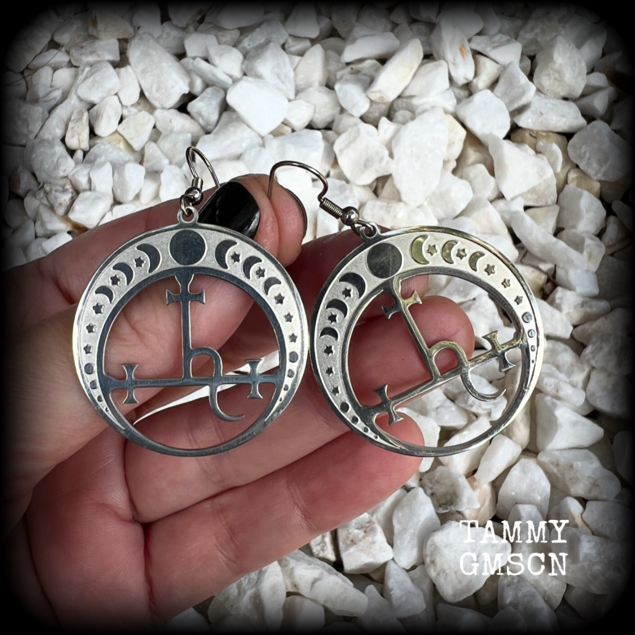These gorgeous stainless steel earrings feature the Sigil of Lilith surrounded by moon phases, lovely and light weight at only 5 grams each, and measure just over 5.5cms from tip to tip.


This pair have been made with stainless steel french hooks, to be worn in pierced ears.
