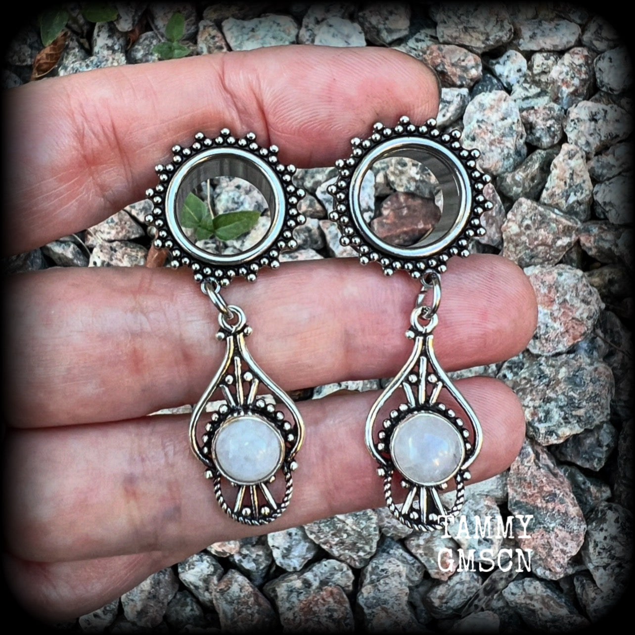 These beautiful earrings have been made with gorgeous polished rainbow moonstone gemstones in a beautiful boho antique silver setting, are nice and light weight, weighing approx 8 grams each and measuring 5cm from tip to tip. 

These gorgeous tunnel dangles have been made with 9/16" (14mm) gauge surgical steel ornate screw fit tunnels.