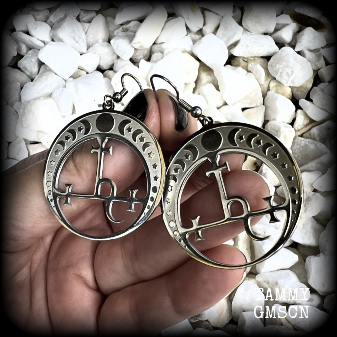 These gorgeous stainless steel earrings feature the Sigil of Lilith surrounded by moon phases, lovely and light weight at only 5 grams each, and measure just over 5.5cms from tip to tip.


This pair have been made with stainless steel french hooks, to be worn in pierced ears.

