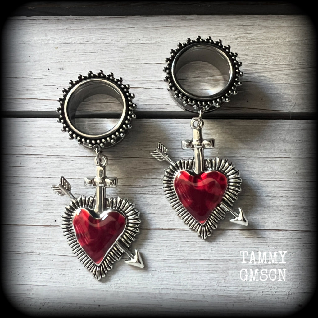 These gorgeous tunnel earrings feature beautiful antique silver and red enamel hearts pierced by silver arrows, are nice and lightweight, weighing only 12 grams each and measure approx 7cms from tip to tip.

This pair has been made with 3/4" (19mm) gauge ornate surgical steel screw fit tunnels.