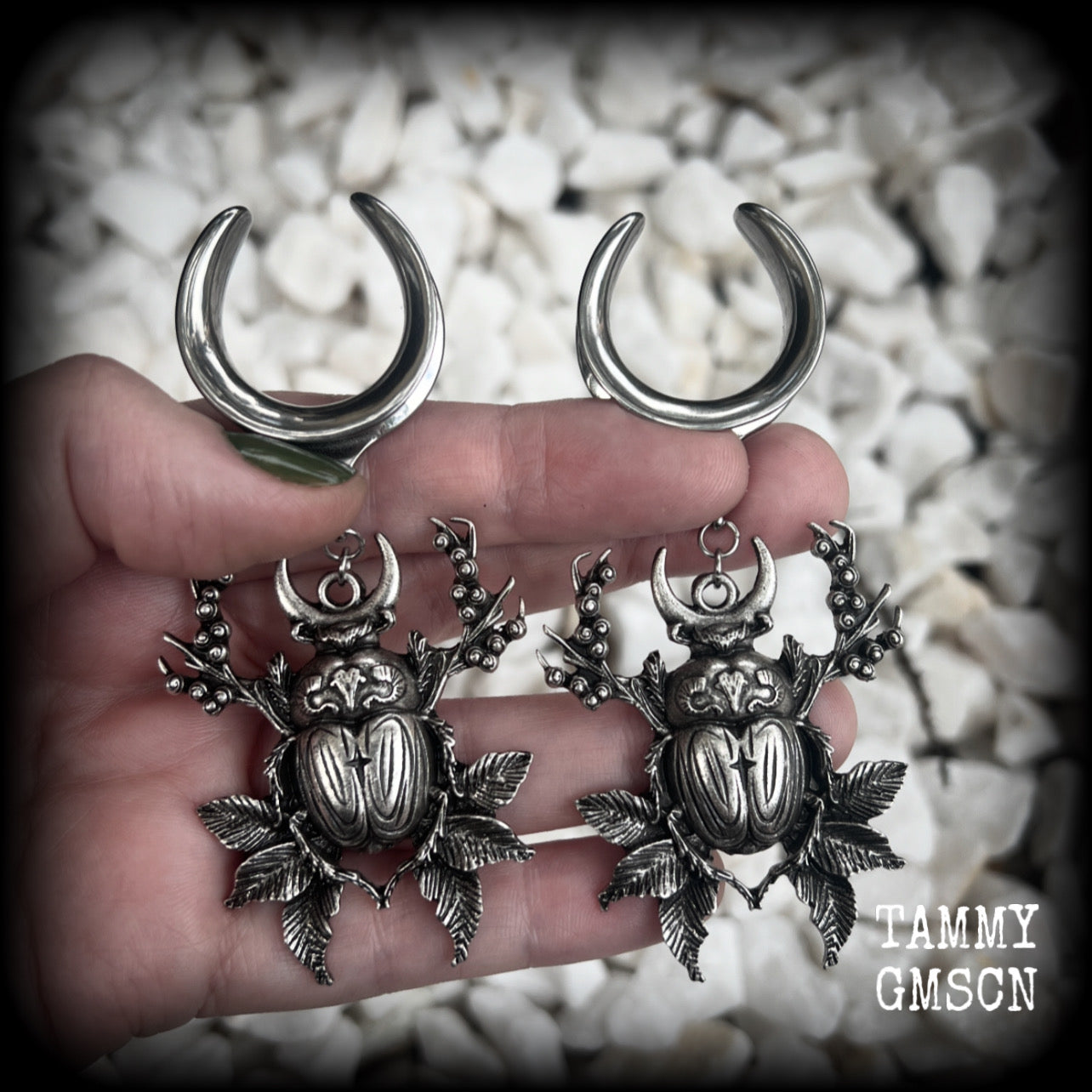 These gorgeous earrings feature large antique silver scarab beetles surrounded by berries and leaves with a crescent moon, measuring just on 9cms from tip to tip, and weighing 20 grams a piece.  This pair has been made on 1” gauge (25mm) gauge surgical steel cradles, to be worn in stretched lobes.