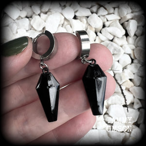 These awesome earrings feature gorgeous black enamel coffins, are nice and lightweight at 3 grams each, and measure in at just over 4cms from tip to tip.

This pair have been made on stainless steel huggie ear cuffs, suitable for pierced ears.
