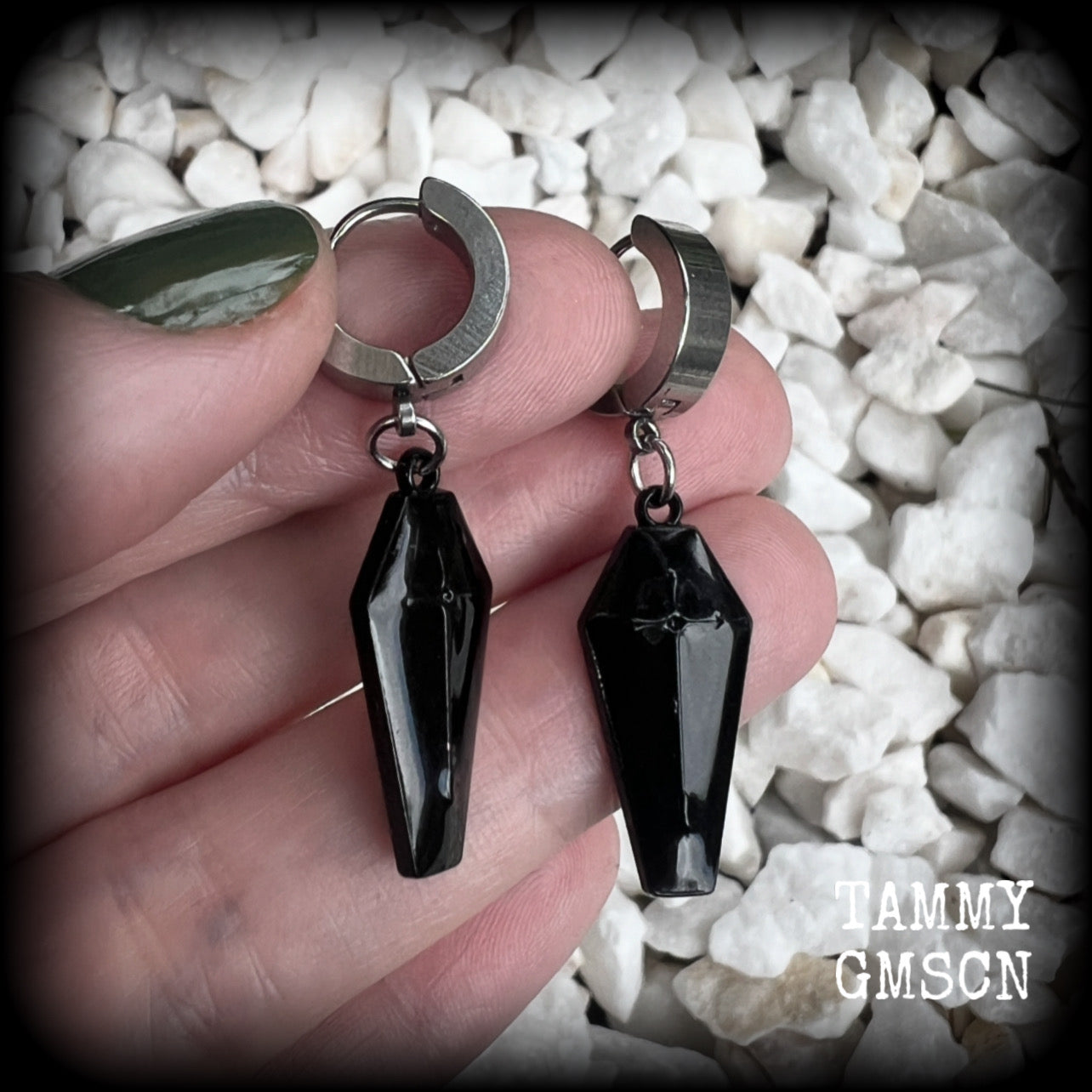 These awesome earrings feature gorgeous black enamel coffins, are nice and lightweight at 3 grams each, and measure in at just over 4cms from tip to tip.

This pair have been made on stainless steel huggie ear cuffs, suitable for pierced ears.