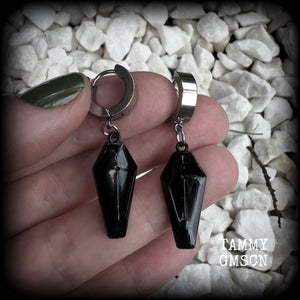 These awesome earrings feature gorgeous black enamel coffins, are nice and lightweight at 3 grams each, and measure in at just over 4cms from tip to tip.

This pair have been made on stainless steel huggie ear cuffs, suitable for pierced ears.
