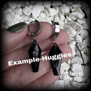 These awesome earrings feature gorgeous black enamel coffins, are nice and lightweight at 3 grams each, and measure in at just over 4cms from tip to tip.

This pair have been made on stainless steel huggie ear cuffs, suitable for pierced ears.