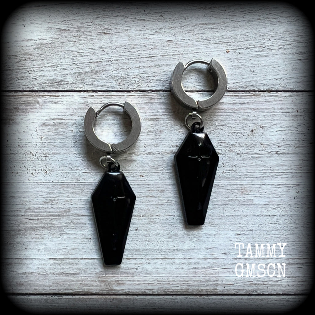 These awesome earrings feature gorgeous black enamel coffins, are nice and lightweight at 3 grams each, and measure in at just over 4cms from tip to tip.

This pair have been made on stainless steel huggie ear cuffs, suitable for pierced ears.