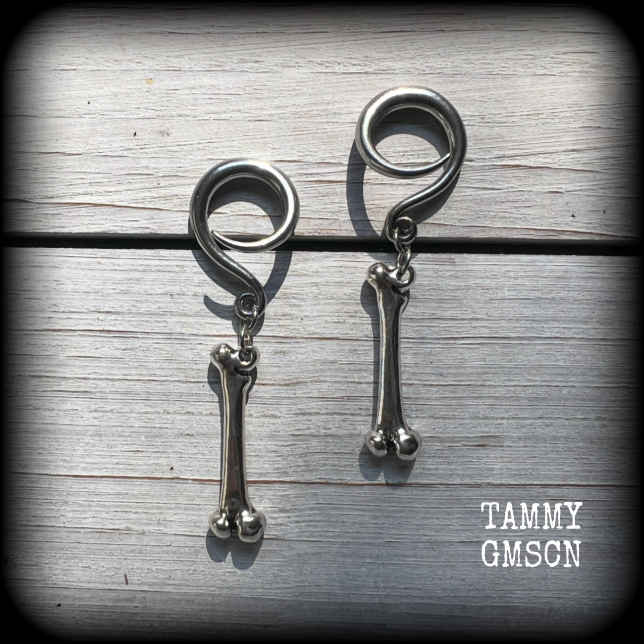 Featuring a pair of awesome antique silver leg bones, these earrings are super lightweight, weighing in at only 7 grams a piece, and are nice and dangly at just on 6.5cms.

This pair has been made on 6 gauge (4mm) surgical steel full curl hooks, to be worn in stretched lobes.

