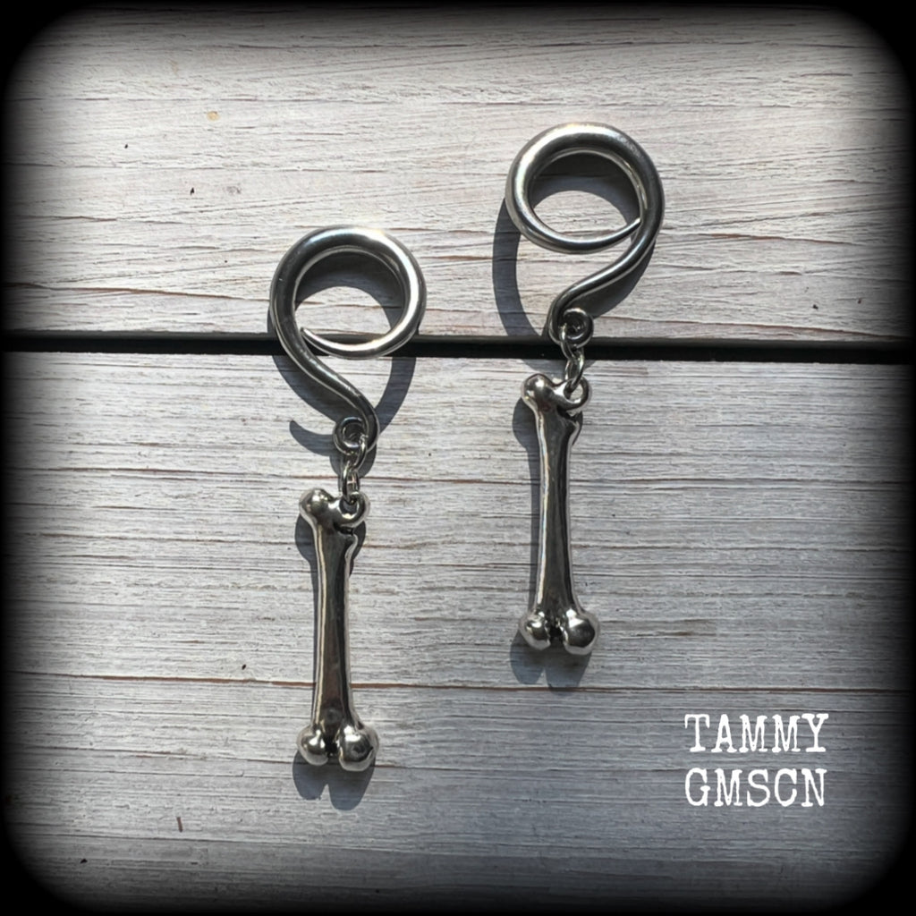 Featuring a pair of awesome antique silver leg bones, these earrings are super lightweight, weighing in at only 7 grams a piece, and are nice and dangly at just on 6.5cms.

This pair has been made on 6 gauge (4mm) surgical steel full curl hooks, to be worn in stretched lobes.

