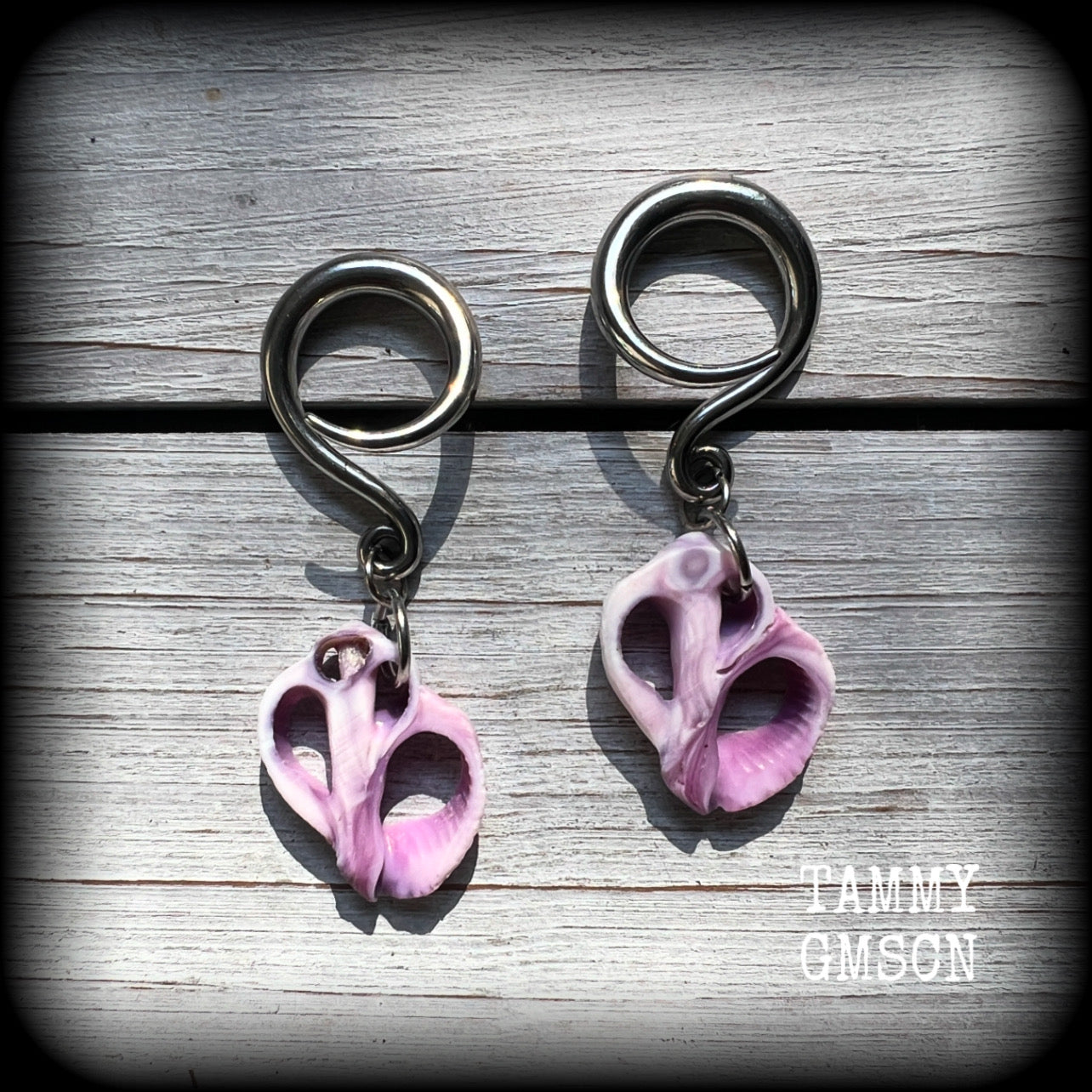 These gorgeous gauged earrings feature beautiful purple sea shell slices, weighing in approx 5 grams a piece, and measuring approx 5.5cms from tip to tip.

This pair has been made on 6 gauge (4mm) surgical steel full curl hooks, to be worn in stretched lobes.