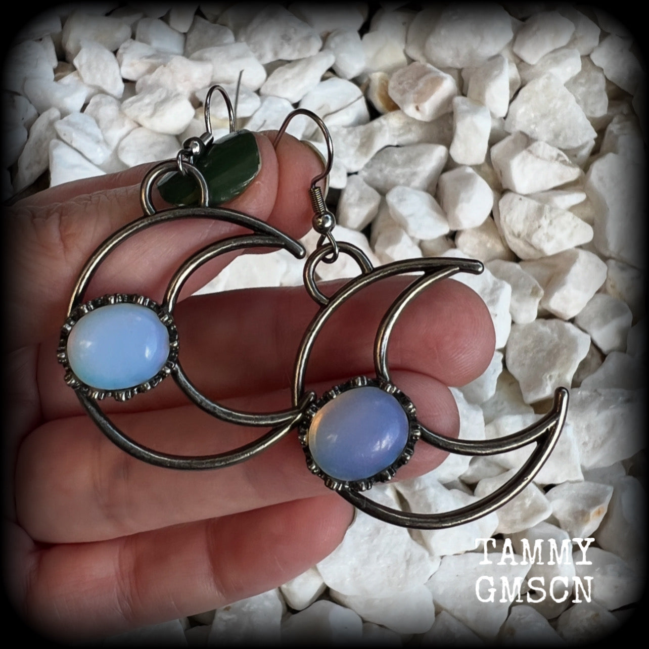 These gorgeous gunmetal grey crescent moon earrings feature beautiful milky white opalite gemstones, nice and dangly measuring approx 5.5cms from tip to tip, and are nice and light weight at around 5 grams each.

This pair has been made with stainless steel french hooks, suitable for pierced ears.