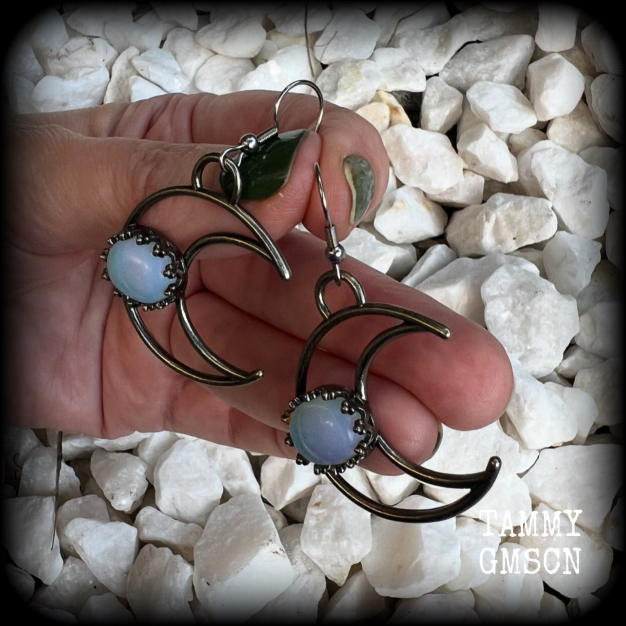 These gorgeous gunmetal grey crescent moon earrings feature beautiful milky white opalite gemstones, nice and dangly measuring approx 5.5cms from tip to tip, and are nice and light weight at around 5 grams each.

This pair has been made with stainless steel french hooks, suitable for pierced ears.