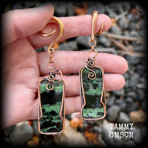 These beautiful steampunk inspired gauged earrings feature gorgeous big rustic wire wrapped ruby zoisite gemstones, measuring 9.5cms from tip to tip, and weighing approx 20 grams each.

This pair has been made on 2 gauge (6mm) titanium coated surgical steel full curl hooks, suitable for stretched lobes.