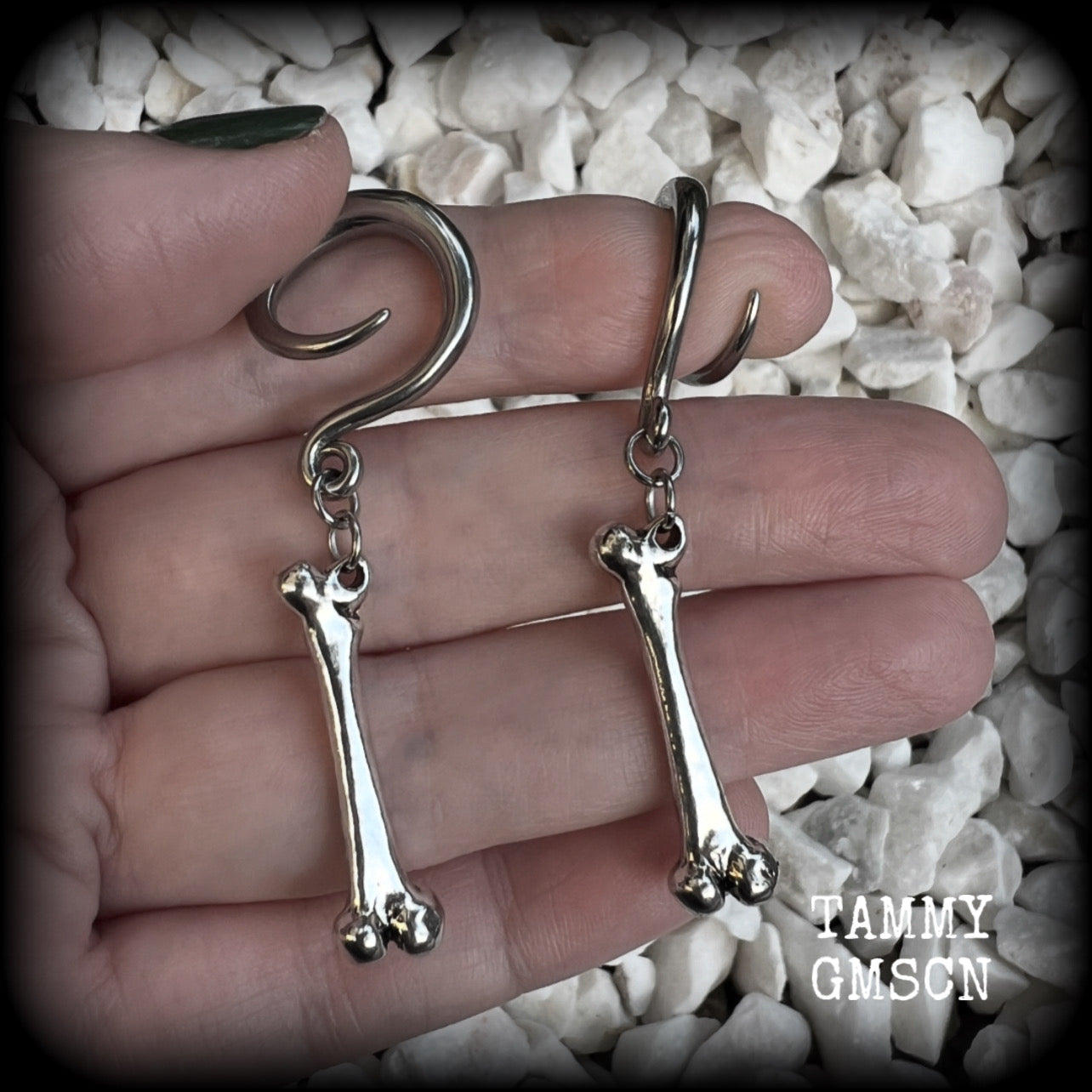 Featuring a pair of awesome antique silver leg bones, these earrings are super lightweight, weighing in at only 7 grams a piece, and are nice and dangly at just on 6.5cms.

This pair has been made on 6 gauge (4mm) surgical steel full curl hooks, to be worn in stretched lobes.

