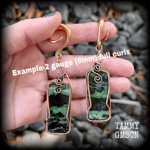 These beautiful steampunk inspired gauged earrings feature gorgeous big rustic wire wrapped ruby zoisite gemstones, measuring 9.5cms from tip to tip, and weighing approx 20 grams each.

This pair has been made on 2 gauge (6mm) titanium coated surgical steel full curl hooks, suitable for stretched lobes.