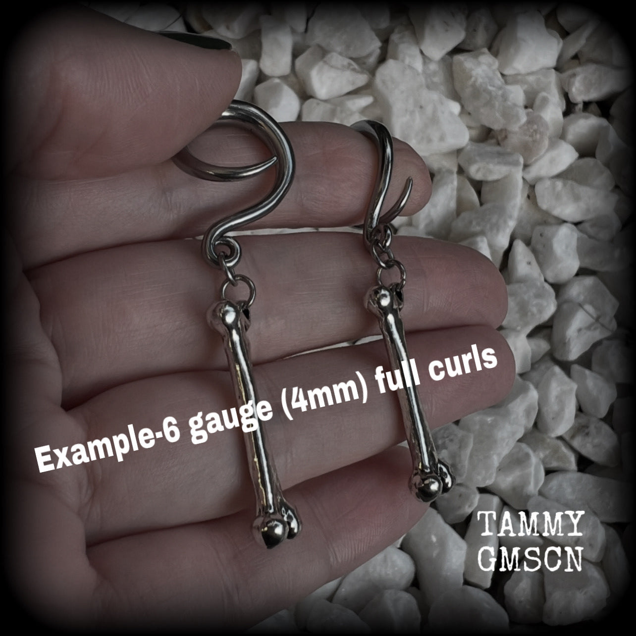 Featuring a pair of awesome antique silver leg bones, these earrings are super lightweight, weighing in at only 7 grams a piece, and are nice and dangly at just on 6.5cms.

This pair has been made on 6 gauge (4mm) surgical steel full curl hooks, to be worn in stretched lobes.

