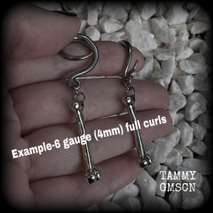 Featuring a pair of awesome antique silver leg bones, these earrings are super lightweight, weighing in at only 7 grams a piece, and are nice and dangly at just on 6.5cms.

This pair has been made on 6 gauge (4mm) surgical steel full curl hooks, to be worn in stretched lobes.

