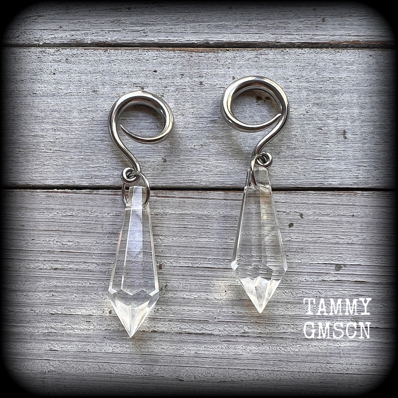 These gorgeous dangly glass earrings have been made with gorgeous faceted faux glass spears, measuring 6.5 cms from tip to tip, and weighing approx 8 grams each.

These earrings have been made on 6 gauge (4mm) surgical steel full curls, to be worn in stretched lobes.