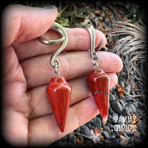 These gorgeous gauged earrings have been made with beautiful brick red jasper pendulums, measuring just over 7 cms from tip to tip, and weighing approx 14 grams each.

This pair has been made on 2 gauge (6mm) surgical steel full curl hooks, to be worn in stretched lobes.